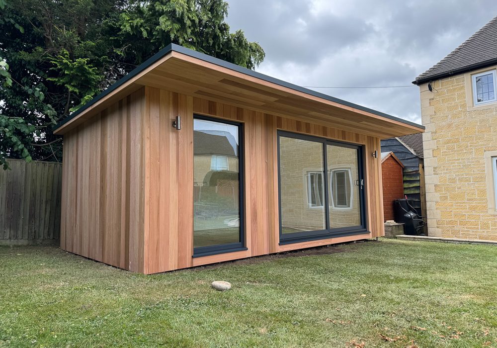 This 6m x 3.5m bespoke garden gym by Sanctum Garden Studios adapts their Contemporary Overhang range with a reinforced floor, extended cedar-clad canopy, generous sliding doors and tailored electrics, including an air source heat pump for year-round workouts at home.