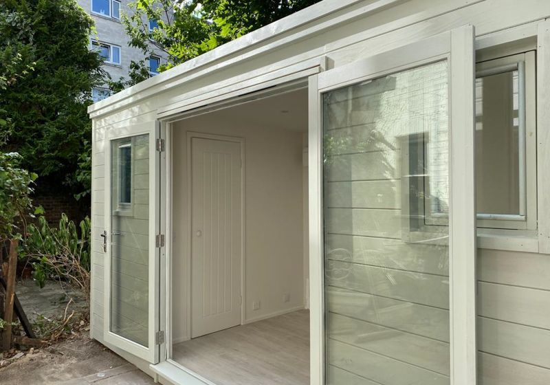 Exterior view of the bespoke Crusoe Garden Room with the French doors open