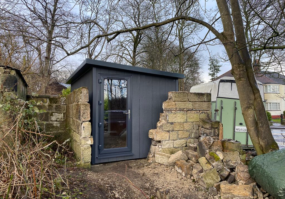 Sanctum Garden Studios designed this office/music room to sit within sections of derelict walls
