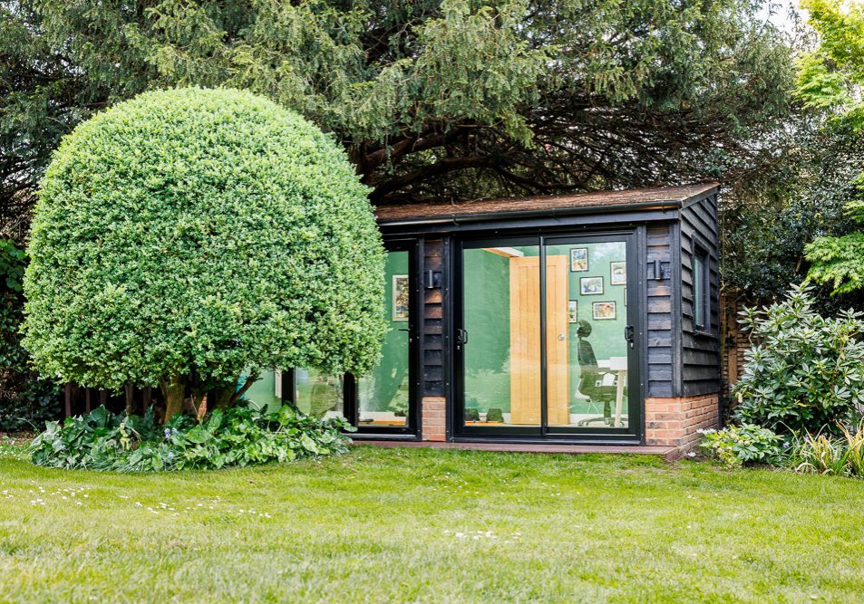 The garden room blends into the garden setting