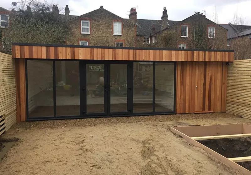 The garden room slots in tight to three boundary fences