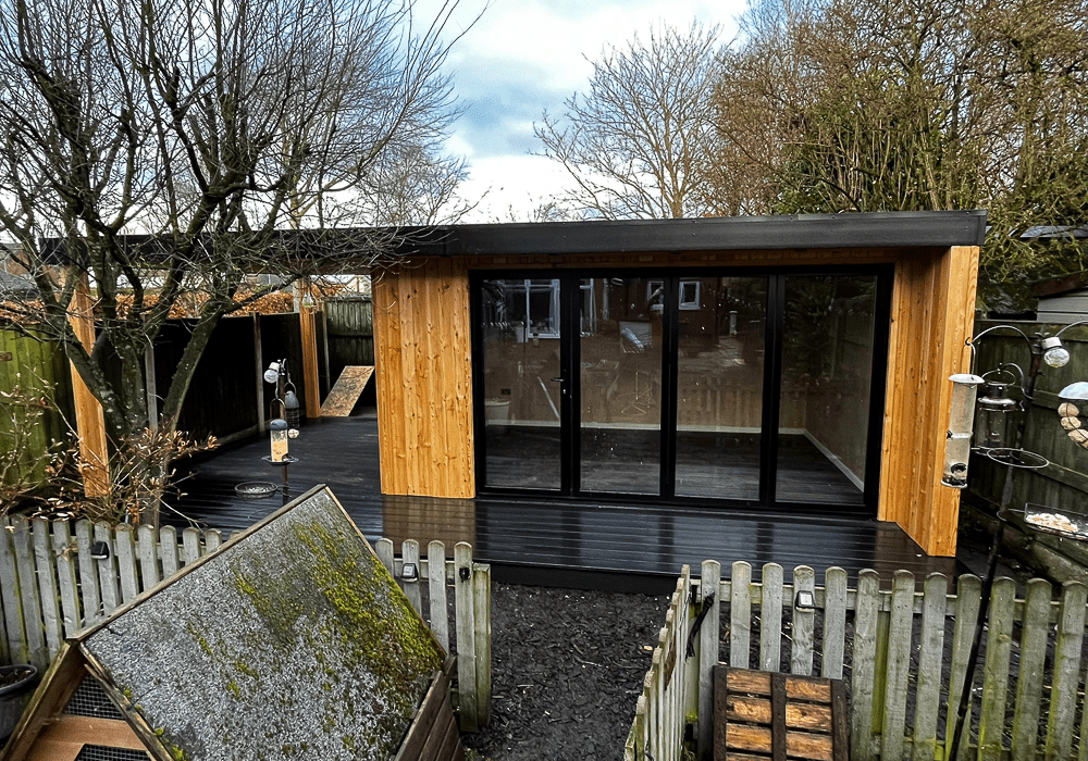 4.5m x 3.3m Heritage Garden Studios building for use as a garden dining room with an open-sided covered area for a hot tub.