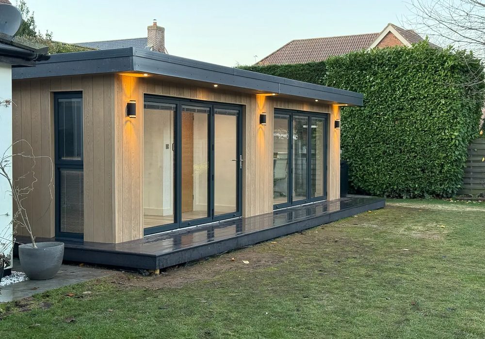 The 8m x 4m garden room sits at the side of the family garden overlooking the lawn