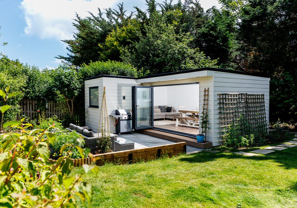 L-shaped garden room by Miniature Manors designed as a home office and family entertainment space