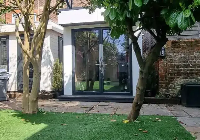 The L-shaped garden gym slots in beside an existing garden office