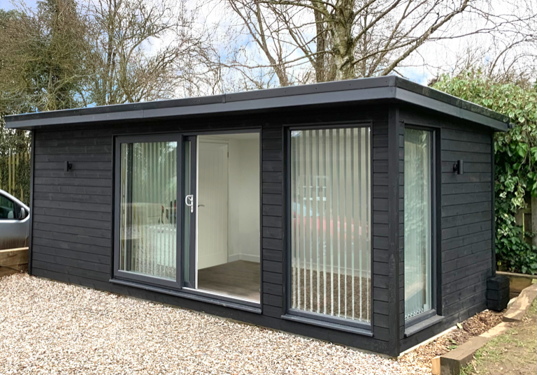 Charcoal grey clad outdoor office by AMC Garden Rooms