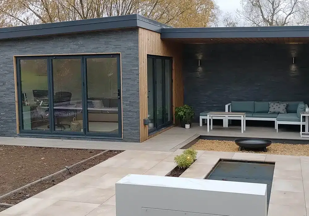 Angled view of the garden office showcasing the mix of slate cladding and Thermowood.