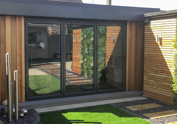 L-shape man cave by Swift Garden Rooms