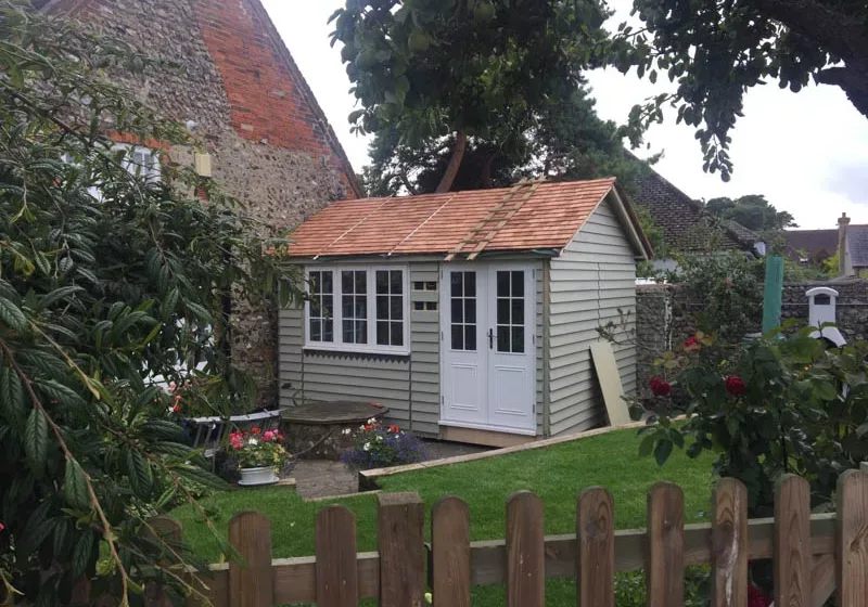 A beautifully tiled cedar shingle roof and traditional detailing