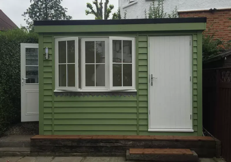 Painted flat roof garden office with shed